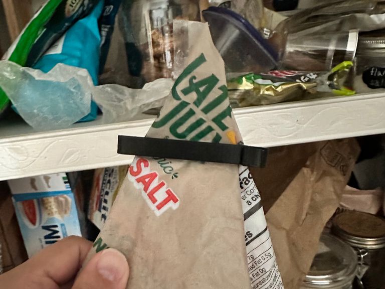 A batch of clips of varying sizes stuck to a refrigerator door