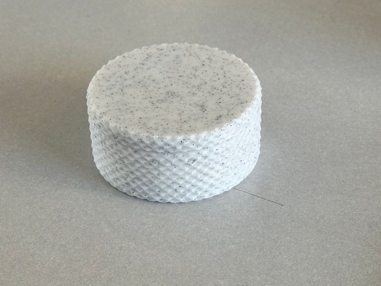 The pill case with the top screwed on. It is flat on top. The knurled outer texture of the lid and compartment match.